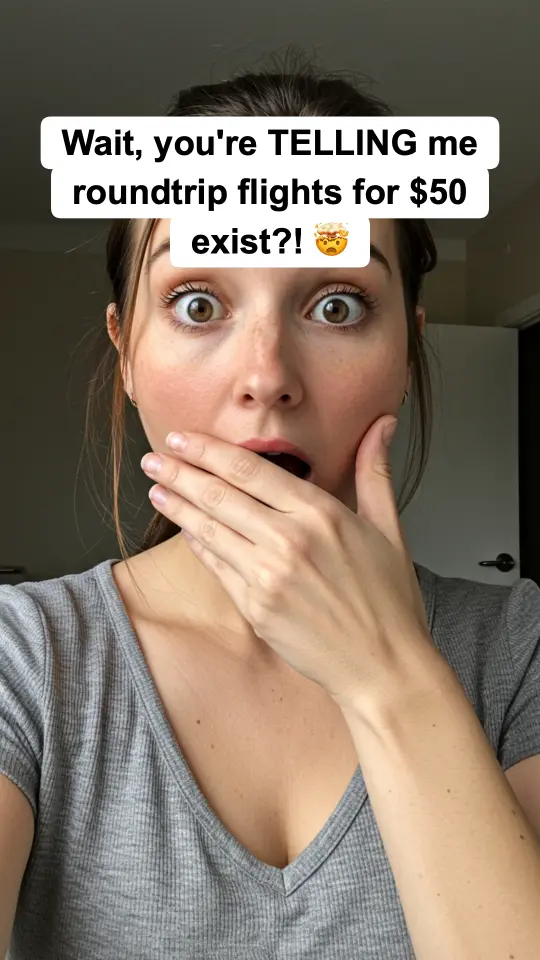 Slideshow slide: shocked selfie with the hook text 'Wait, you're TELLING me roundtrip flights for $50 exist?!'